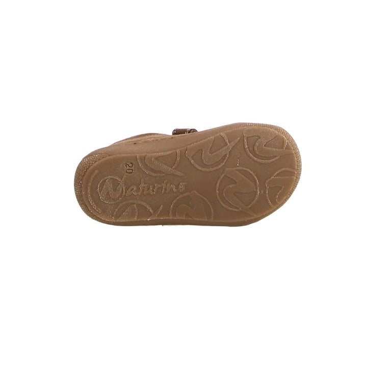 Brown sandal sole with brand name on a white background