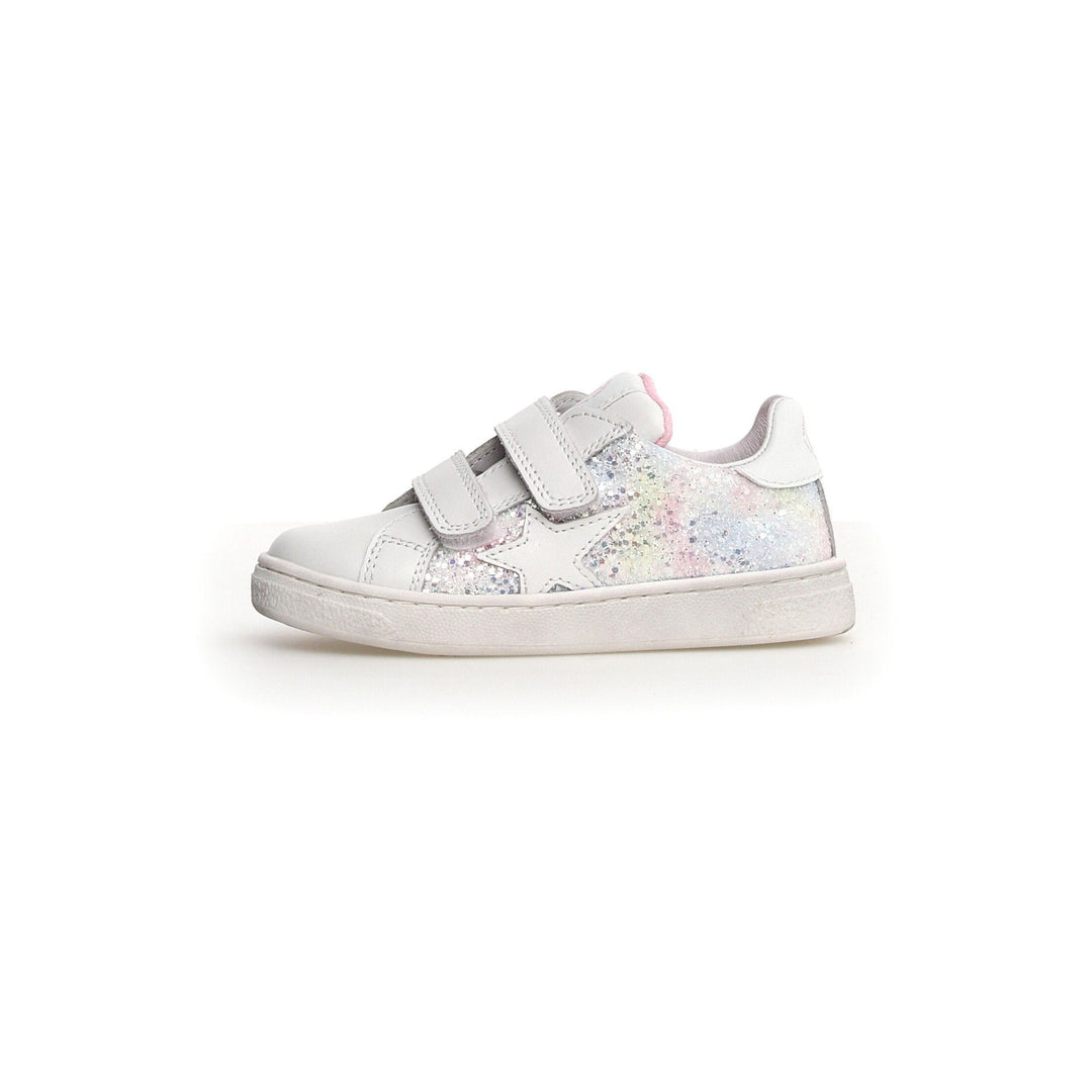 A white Naturino Pinn VL sneaker for toddlers with a glittered patch on the side and double Velcro straps.