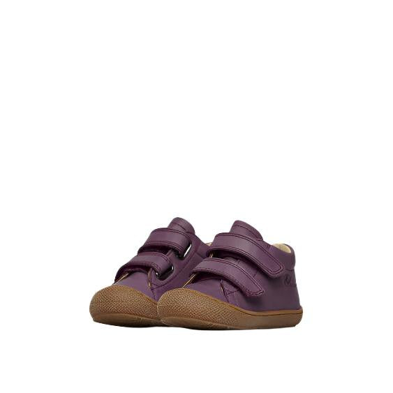 Pair of purple children's shoes with brown soles on a white background