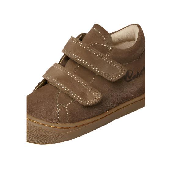 Brown children's shoe with velcro straps on a white background