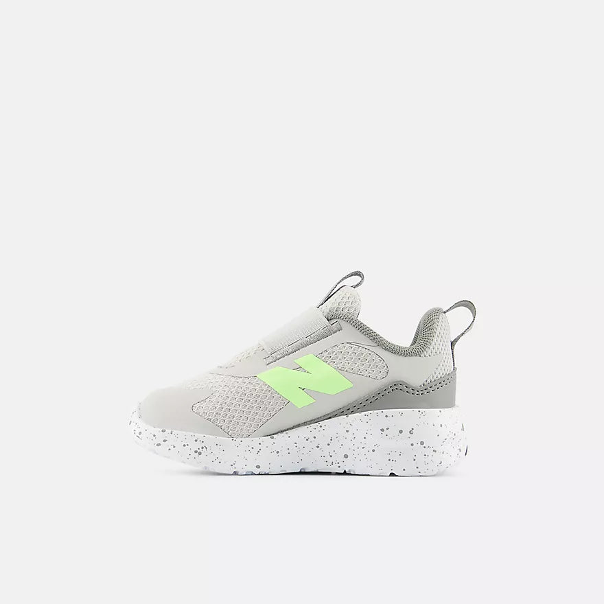 Gray sneaker with a green accent on a white background