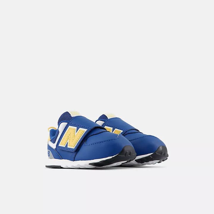 A pair of New Balance toddler sneakers in royal blue with a large yellow &