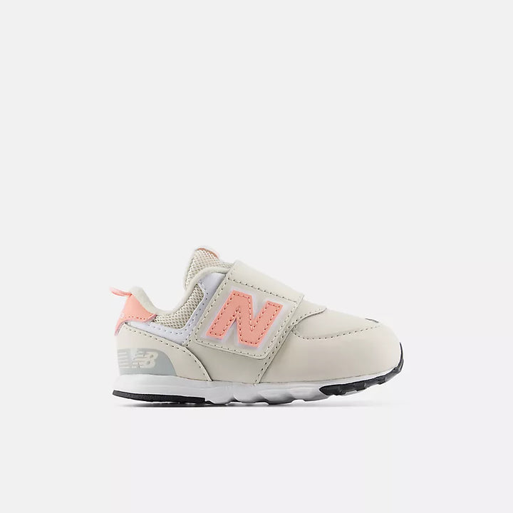 Beige and pink sneaker with New Balance logo on a white background