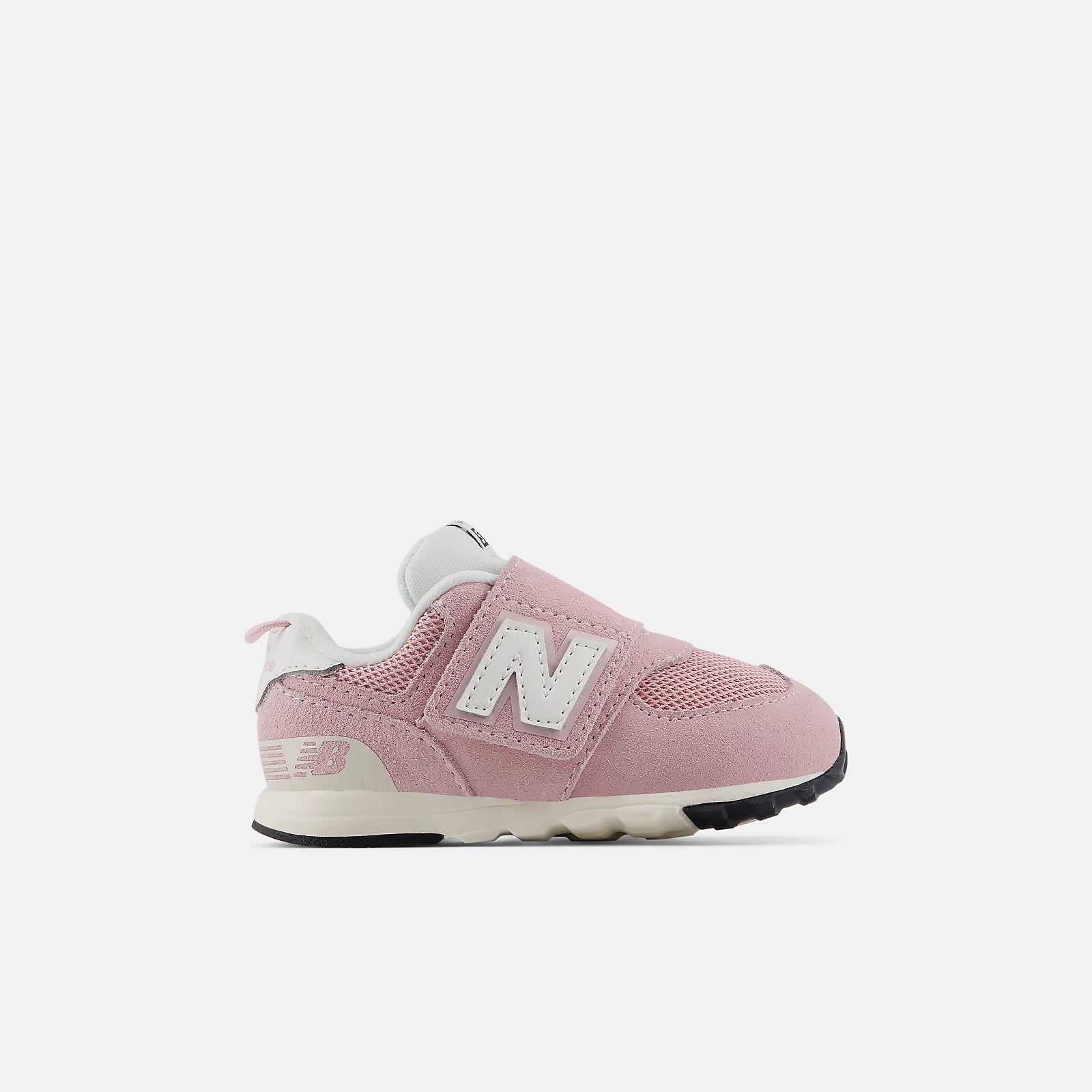 A pink New Balance 590 sneaker for toddlers, featuring a pink mesh and suede upper, a white 'N' logo, and a white and beige midsole with a black outsole, shown against a light gray background.