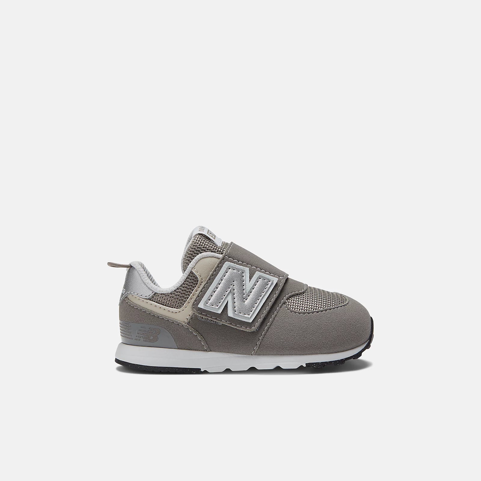 A toddler-sized New Balance 574 sneaker with hook and loop closure, in a gray color.