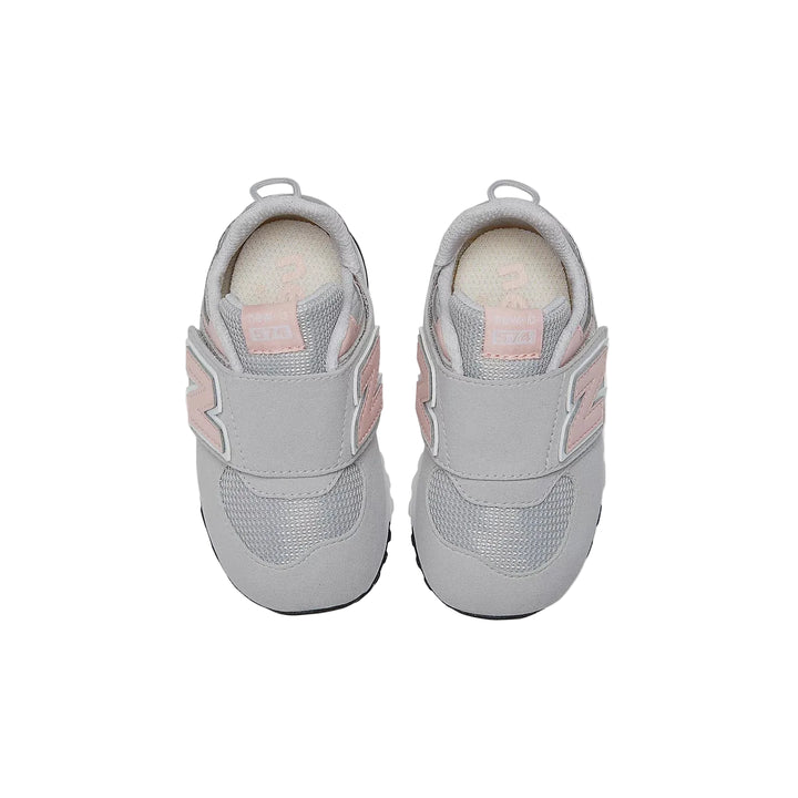 Pair of gray children's sneakers with pink accents on a white background