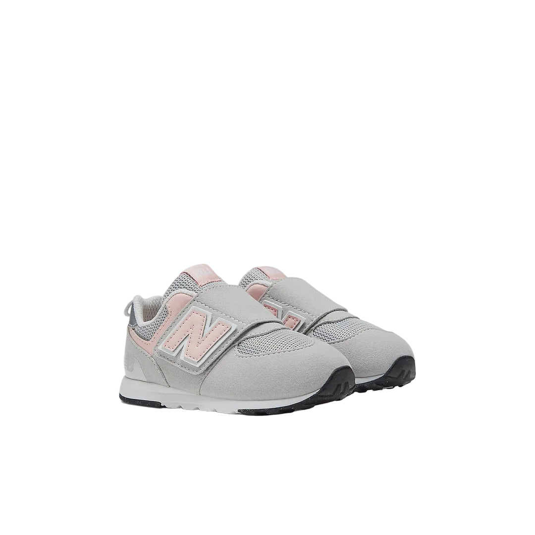 Gray sneakers with pink accents on a white background