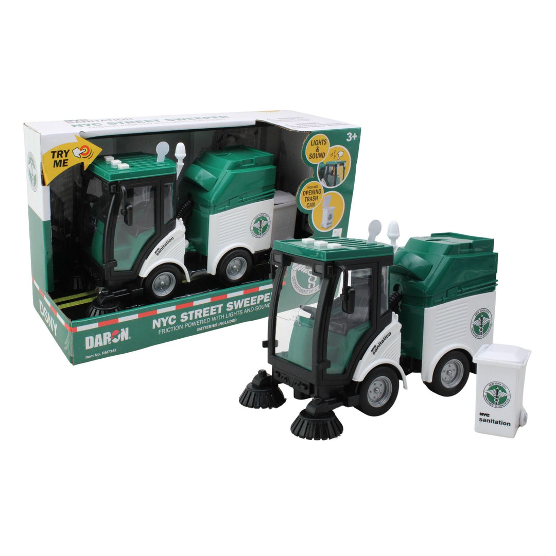A green and white Daron 1:16 scale street sweeper toy with rubberized wheels, lights, and a detachable trash can, packaged in a product box.