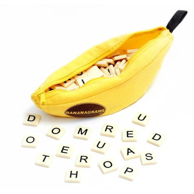 A yellow banana-shaped storage case with the word 'Bananagrams' branded on it, containing various colorful word tiles spilled out in front.